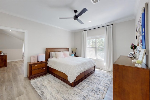 bedroom with light wood-type flooring, ceiling fan, and crown molding