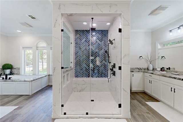 bathroom with vanity, crown molding, and plus walk in shower