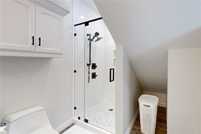 bathroom featuring toilet and walk in shower