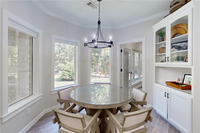 dining space featuring a chandelier and ornamental molding