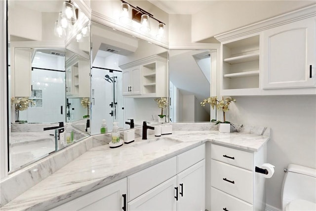 kitchen with white cabinetry, sink, and light stone counters