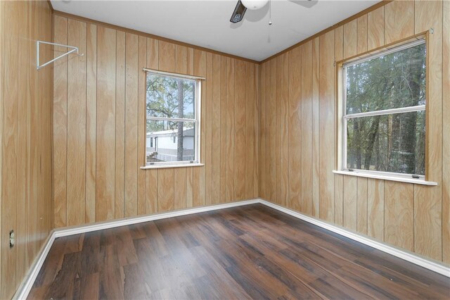 4794 Tall Pine Rd, Navasota, TX 77868 - spare room with a ceiling fan, wood finished floors, and wood walls