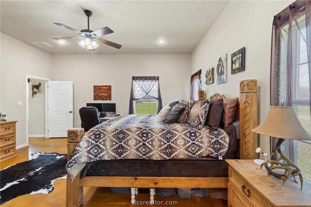 bedroom with light hardwood / wood-style flooring and ceiling fan