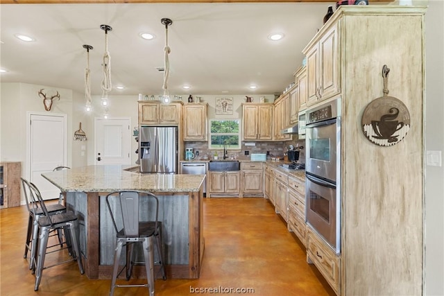 kitchen featuring light stone countertops, a center island, stainless steel appliances, decorative light fixtures, and light brown cabinetry