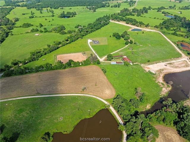 birds eye view of property with a water view and a rural view