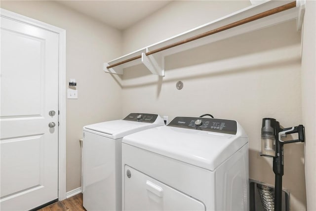 laundry area with laundry area, wood finished floors, and washer and dryer