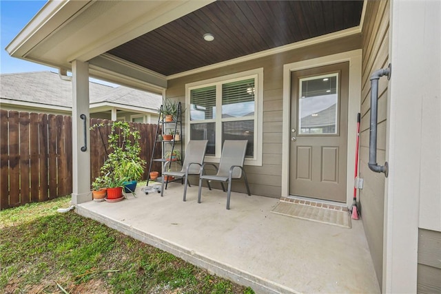 view of patio featuring fence and covered porch