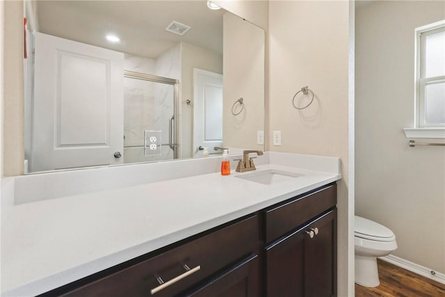 full bath featuring visible vents, a stall shower, wood finished floors, vanity, and toilet