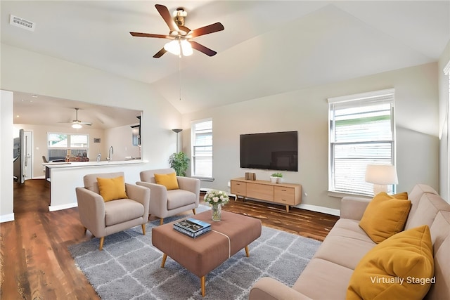 1208 High St, Navasota, TX 77868 - living area featuring vaulted ceiling, a wealth of natural light, a ceiling fan, and wood finished floors