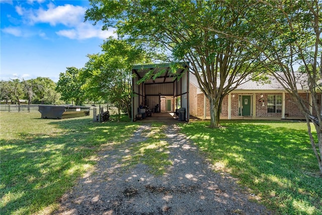 view of yard featuring fence and a detached carport