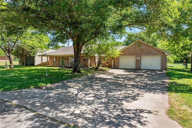 ranch-style house with concrete driveway, brick siding, a garage, and a front yard
