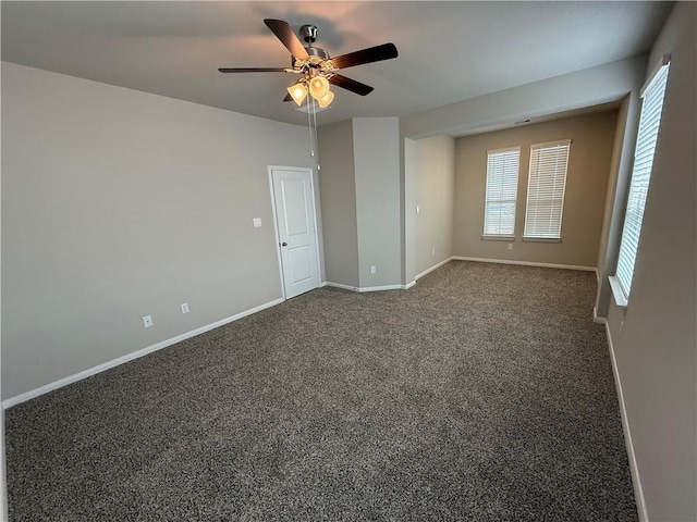 carpeted spare room featuring ceiling fan