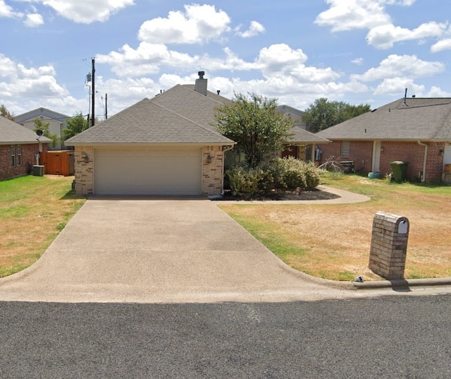 single story home featuring a garage and a front lawn