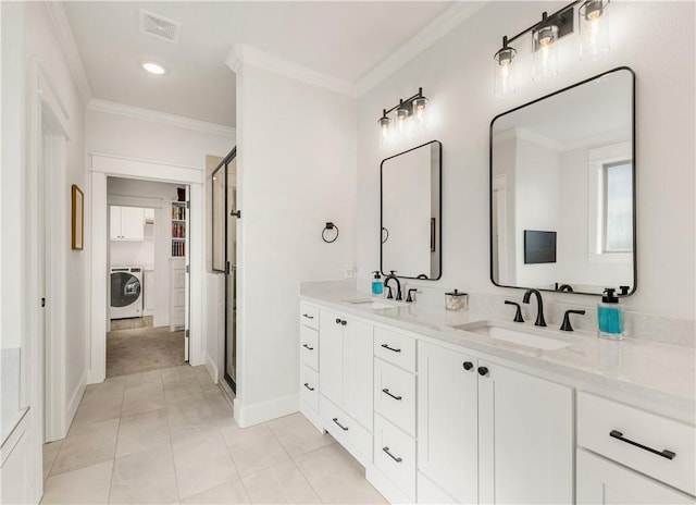 full bath with visible vents, washer / clothes dryer, crown molding, and a sink