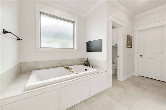 bathroom with tile patterned flooring, toilet, crown molding, and a garden tub