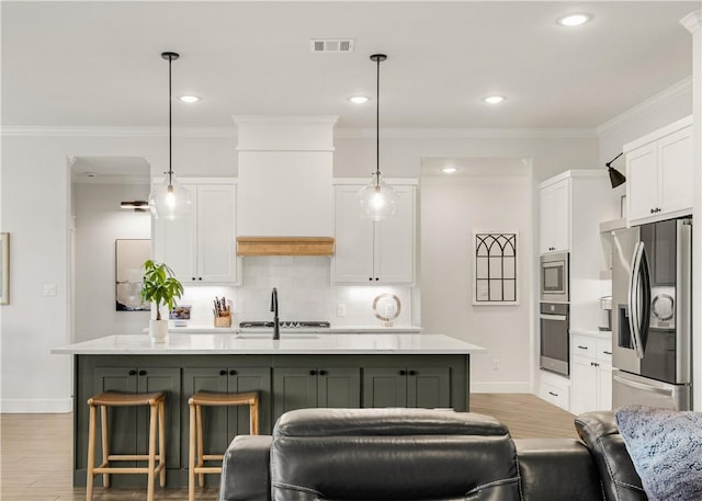 kitchen with decorative backsplash, white cabinetry, stainless steel appliances, and light countertops