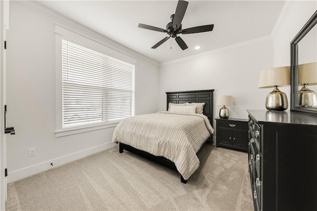 bedroom with a ceiling fan, light colored carpet, baseboards, and ornamental molding