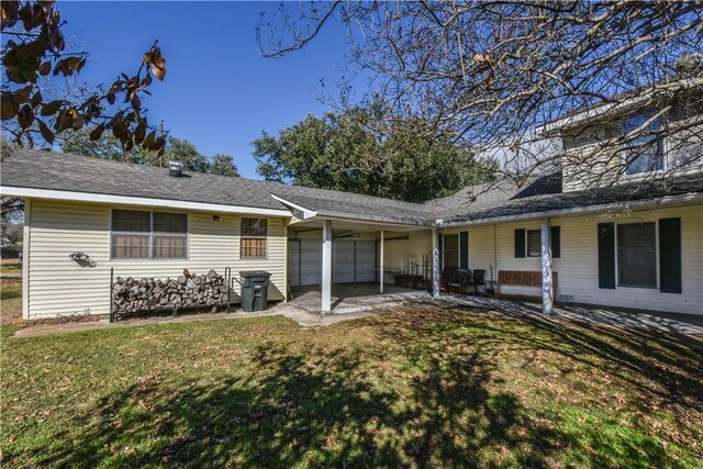 rear view of property with a patio and a lawn