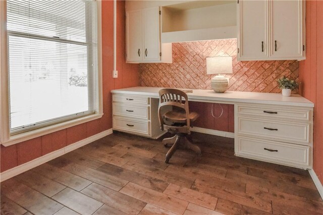 office area with built in desk and hardwood / wood-style flooring