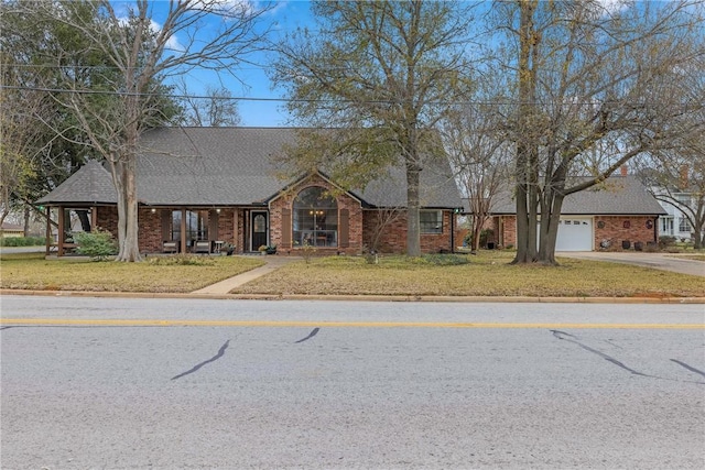 view of front of house with a front yard and a garage