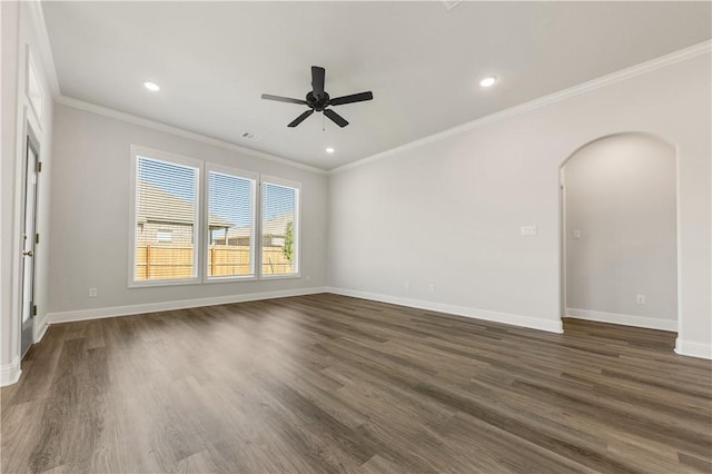 spare room featuring crown molding, dark hardwood / wood-style flooring, and ceiling fan