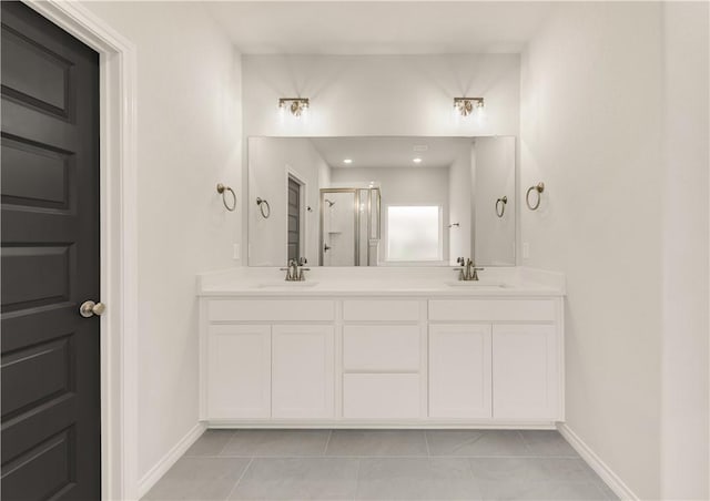 bathroom featuring tile patterned floors, a shower with door, and vanity