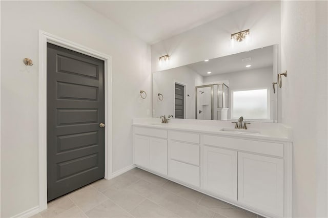 bathroom featuring tile patterned flooring, vanity, and walk in shower