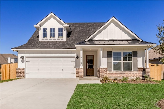 view of front of property featuring a front yard and a garage