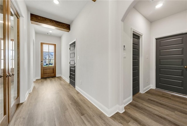 entrance foyer with beamed ceiling and hardwood / wood-style flooring