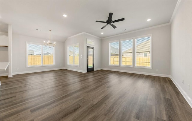 unfurnished living room featuring plenty of natural light, dark hardwood / wood-style floors, ornamental molding, and ceiling fan with notable chandelier