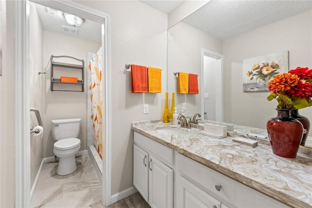 bathroom with vanity, toilet, a shower with shower curtain, and a textured ceiling