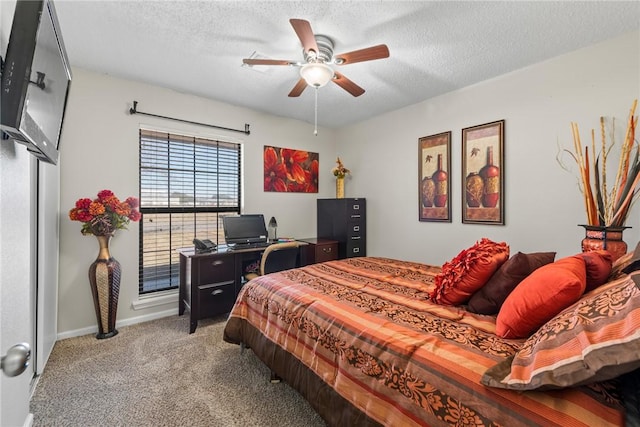 carpeted bedroom featuring a textured ceiling and ceiling fan