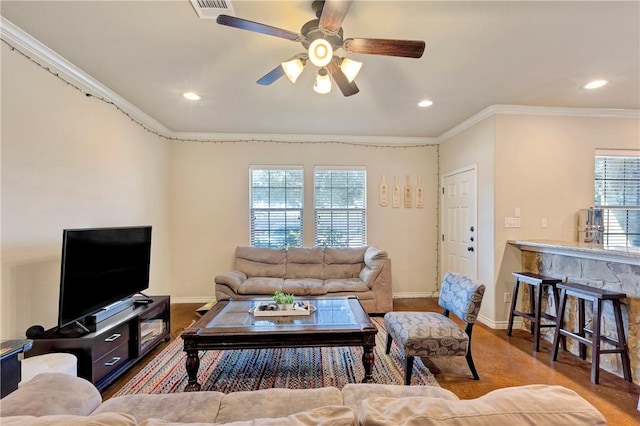 living room with ceiling fan, crown molding, and a wealth of natural light