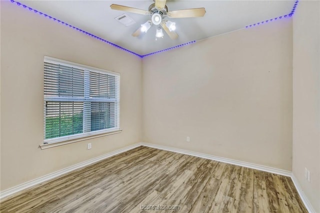 spare room featuring ceiling fan and light hardwood / wood-style floors