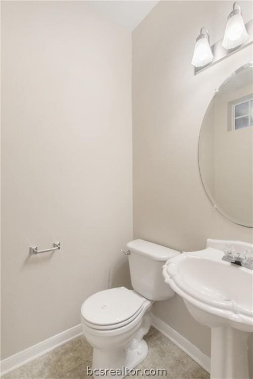 bathroom with tile patterned flooring and toilet