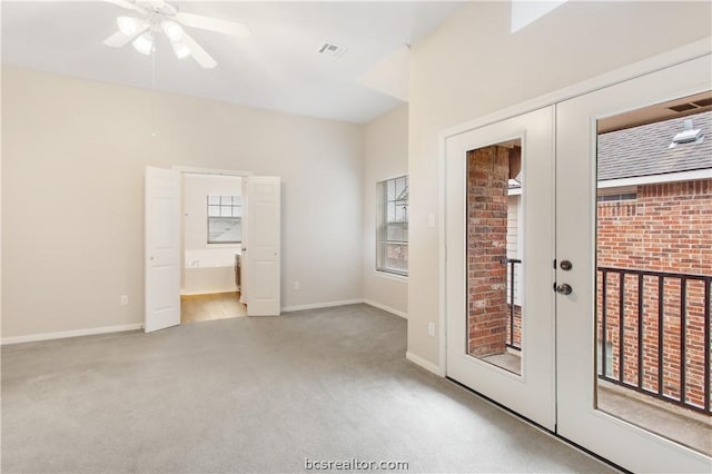 entryway featuring ceiling fan, light carpet, and french doors