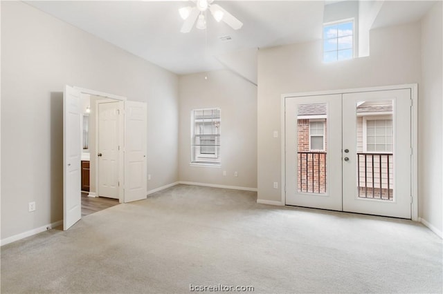 unfurnished room with plenty of natural light, carpet, and french doors