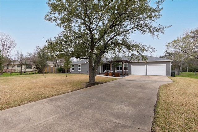 ranch-style house with a garage, a front yard, driveway, and fence