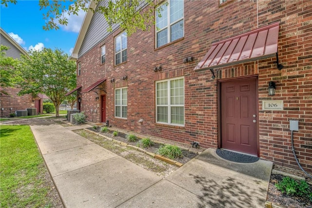 801 Luther St W Unit 106, College Station, TX 77840 - property entrance featuring brick siding, a standing seam roof, and a metal roof