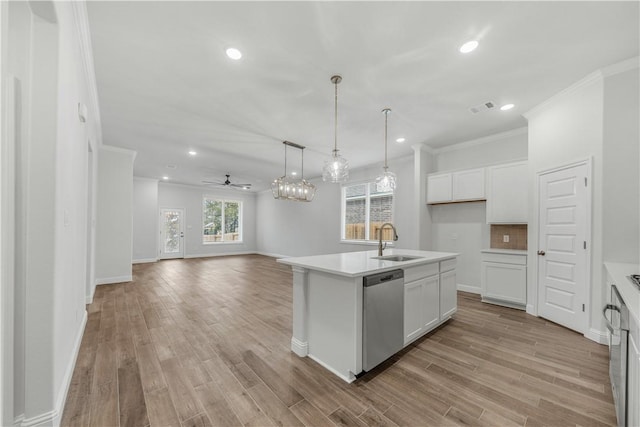 kitchen with sink, stainless steel dishwasher, ceiling fan, an island with sink, and white cabinetry