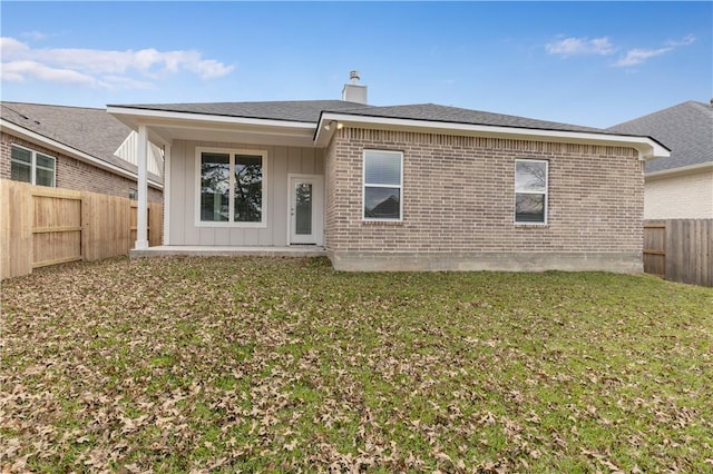 rear view of house with a yard