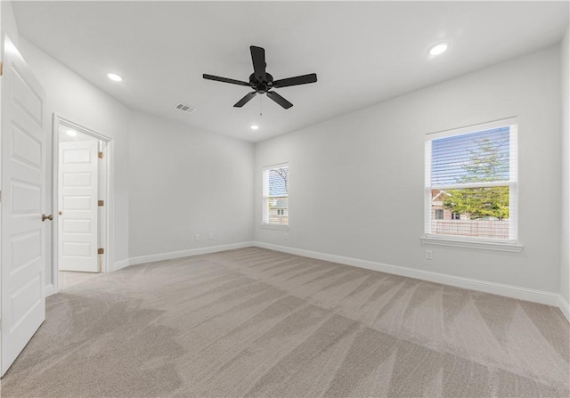 carpeted empty room featuring ceiling fan