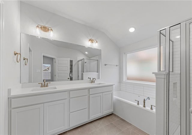 3702 Archer Falls Ct, College Station, TX 77845 - bathroom featuring a bath, double vanity, lofted ceiling, a stall shower, and marble finish flooring