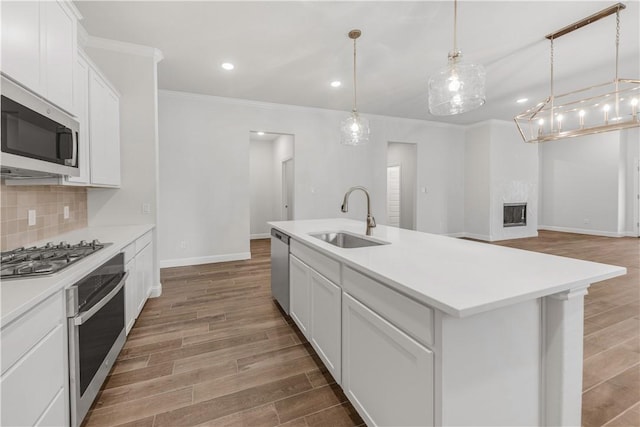 3702 Archer Falls Ct, College Station, TX 77845 - kitchen featuring stainless steel appliances, light wood-style floors, crown molding, tasteful backsplash, and light countertops