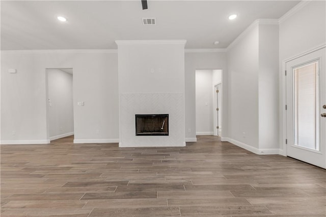 unfurnished living room featuring crown molding and a fireplace