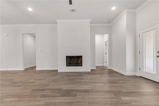 3702 Archer Falls Ct, College Station, TX 77845 - unfurnished living room featuring ornamental molding, wood finished floors, a fireplace, and recessed lighting