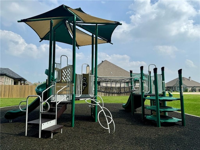 community play area featuring fence and a lawn
