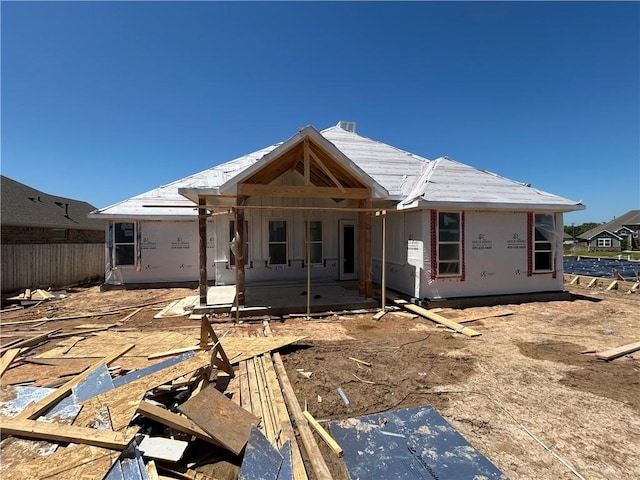 back of property featuring a patio and fence
