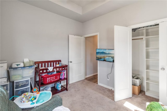 bedroom featuring light carpet and a closet