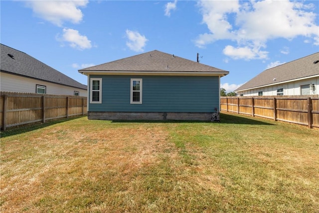 rear view of property with a yard